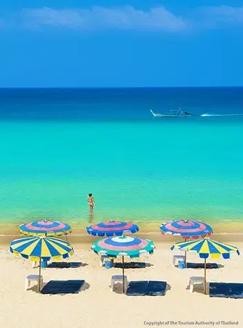 Clear turquoise Andaman Sea and soft white sand at Surin Beach in Phuket Thailand