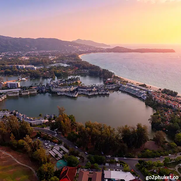 Modern lakeside resort accommodation near Bang Tao Beach with tropical gardens and calm lagoon in Phuket, Thailand