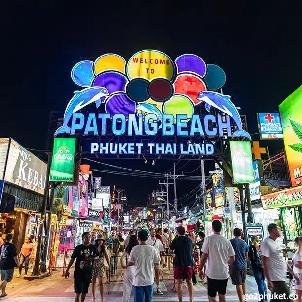 Bright neon lights and busy nightlife crowds along Bangla Road near Patong Beach in Phuket Thailand.