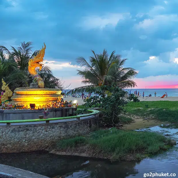 Colorful sunset sky reflecting over the Andaman Sea along the sandy shoreline of Karon Beach in Phuket Thailand.