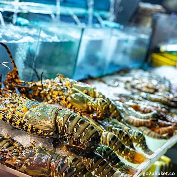 Fresh seafood displayed on ice at Patong Beach fish market in Phuket, Thailand.